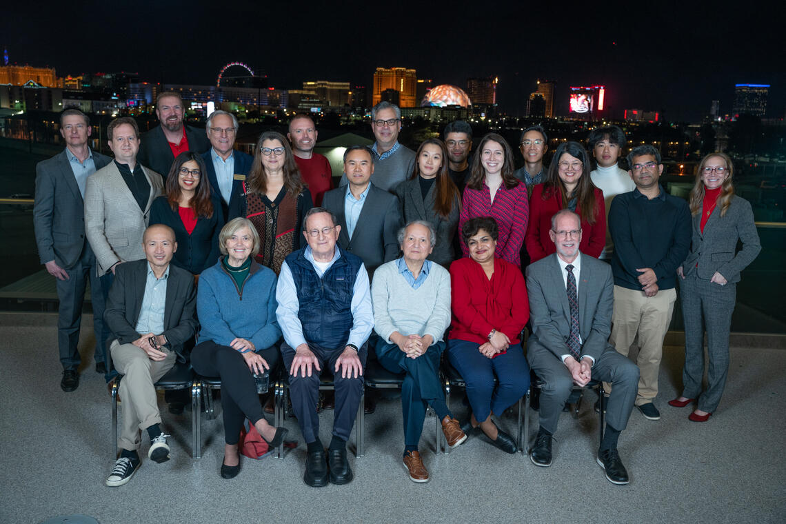 Conference attendees group shot with Las Vegas Strip in the background.