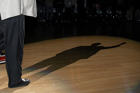 Jerry Tarkanian casting a shadow on stage