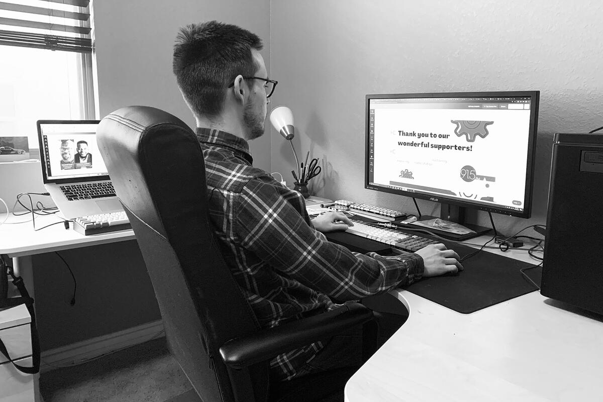 A man sitting down at a computer desk.