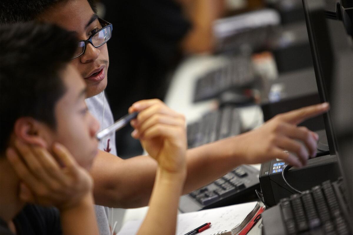 Students pointing at a computer screen