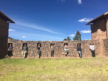 Students sitting in cutouts in a wall