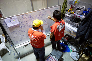 Engineering professor Paul Oh, left, and Kiwon Sohn work through one of the challenges.