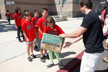 A line of young kids ready to help out the rebel students with moving donated boxes.