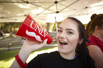 A student with a UNLV themed megaphone.
