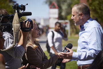 A reporter conducting an interview on UNLV's campus.
