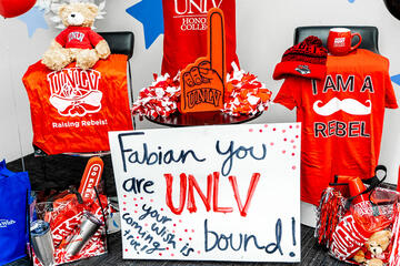 An assortment of UNLV promotional items like teddy bears, foam fingers and tote bags