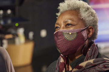 Claytee White is seen wearing a face mask which is patterned to match her outfit