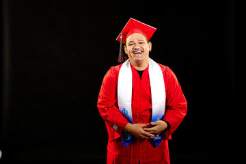 student in red graduation robe and cap