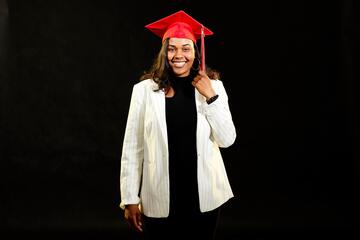 Kennedy Wharton wears a red mortarboard to celebrate graduation