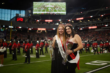 Two women are selected as Rebel Royalty during halftime at a football game