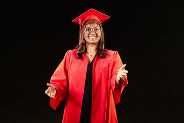 female student with glasses in red graduation gown and cap