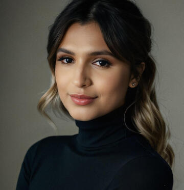 closeup portrait of young woman in black turtleneck