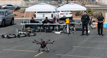 two men flying a drone in parking lot