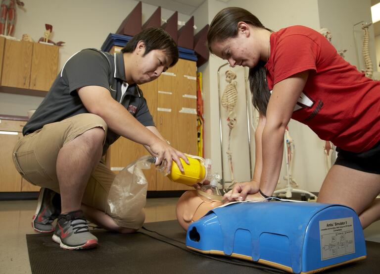 two people doing CPR training