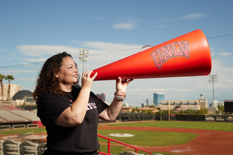 woman holding megaphone in front of face
