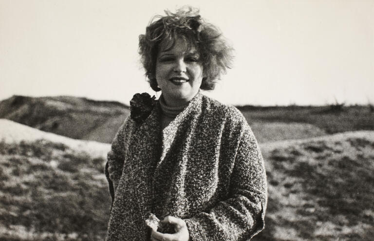 black and white photo of clara bow with dunes behind her