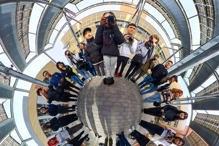 360-degree photo of a large group of students in circle