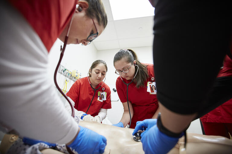 A group of four U.N.L.V. nursing students work on a manikin at the Clinical Simulation Center of Las Vegas.