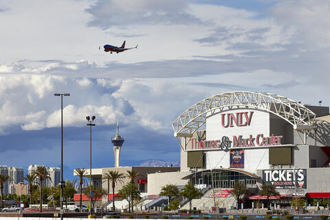 Image of Thomas and Mack Center with plane flying