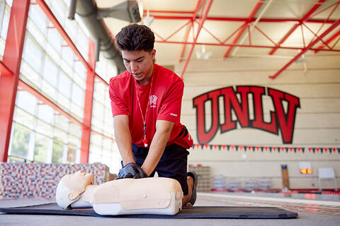 A man giving a practice dummy CPR