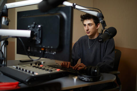 Student working in a radio producer's station