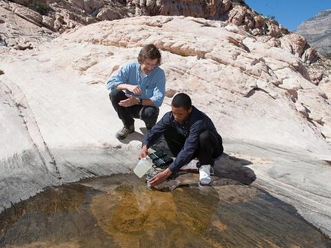 Two men testing water in a mountain