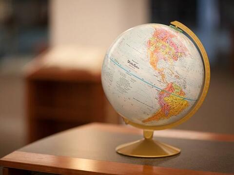 World globe resting on an office desk