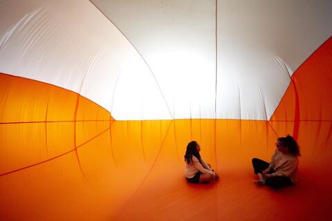 Two people inside an inflatable room