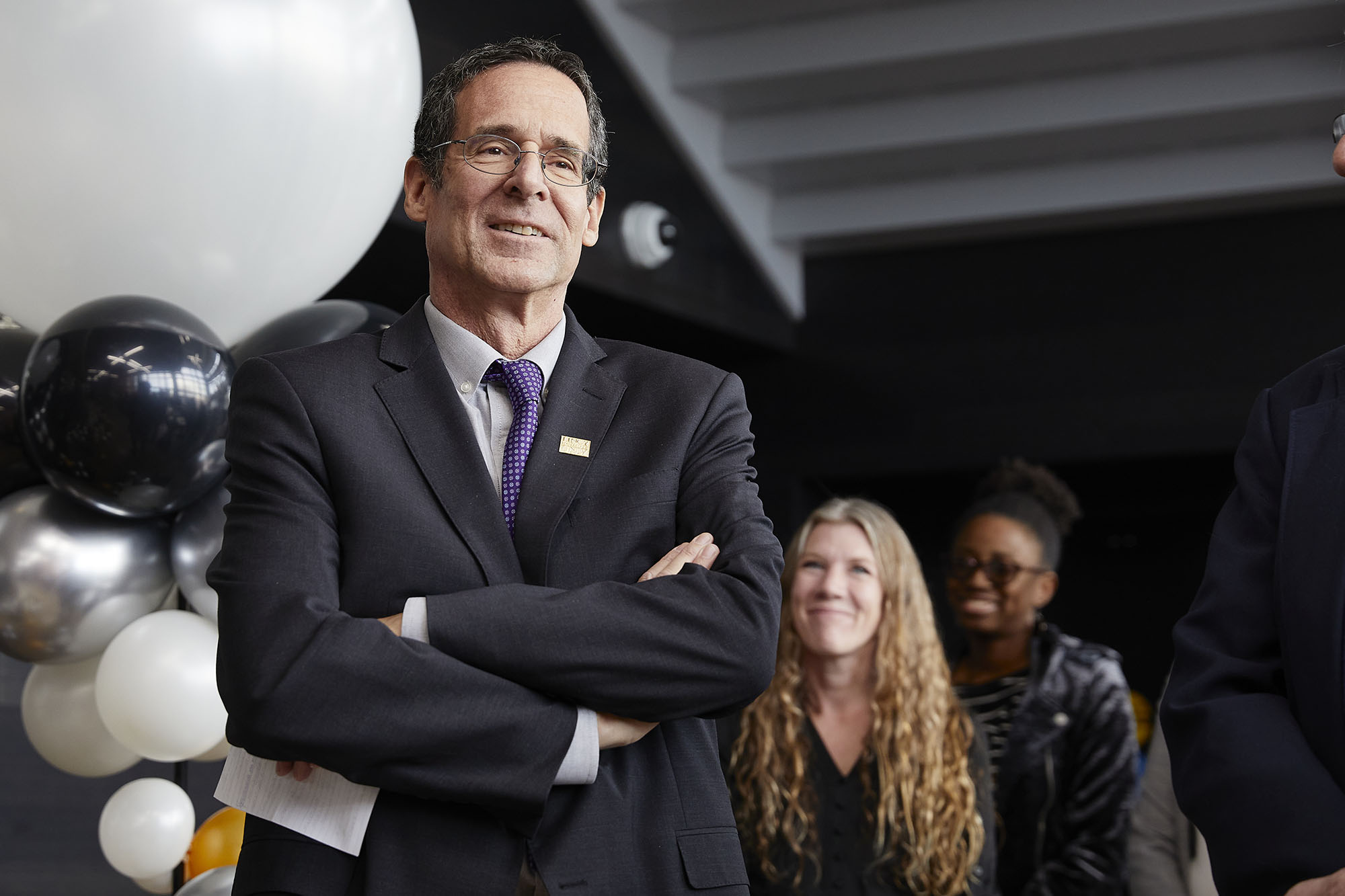 man in suit at a campus celebration