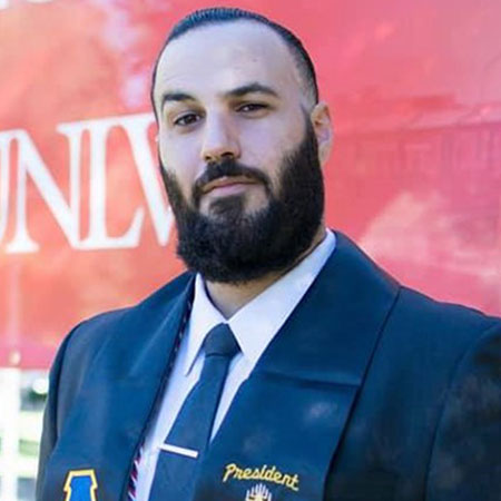 A bearded man wearing a blue suit.