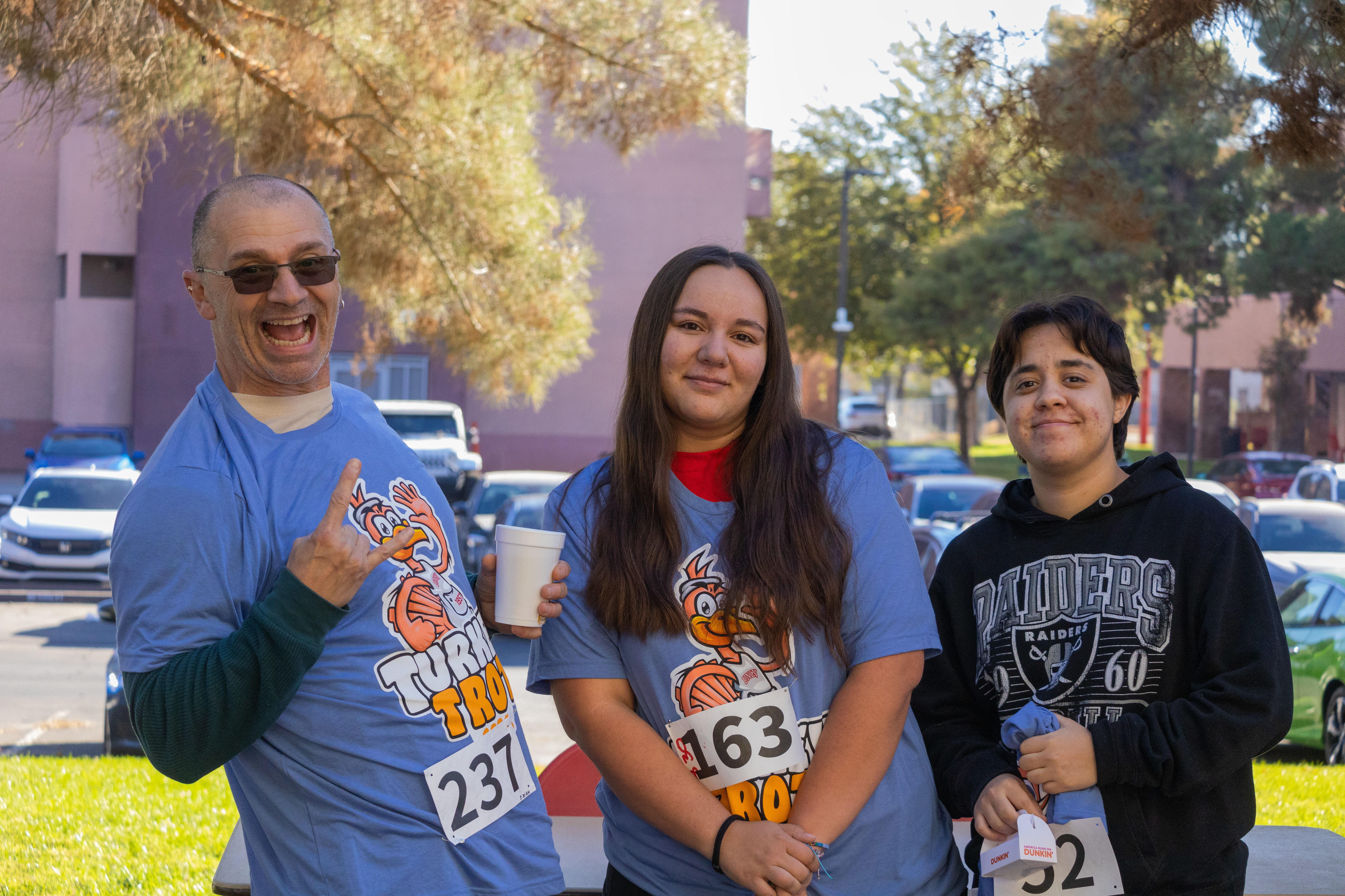Three Turkey Trot participants posing for a photo