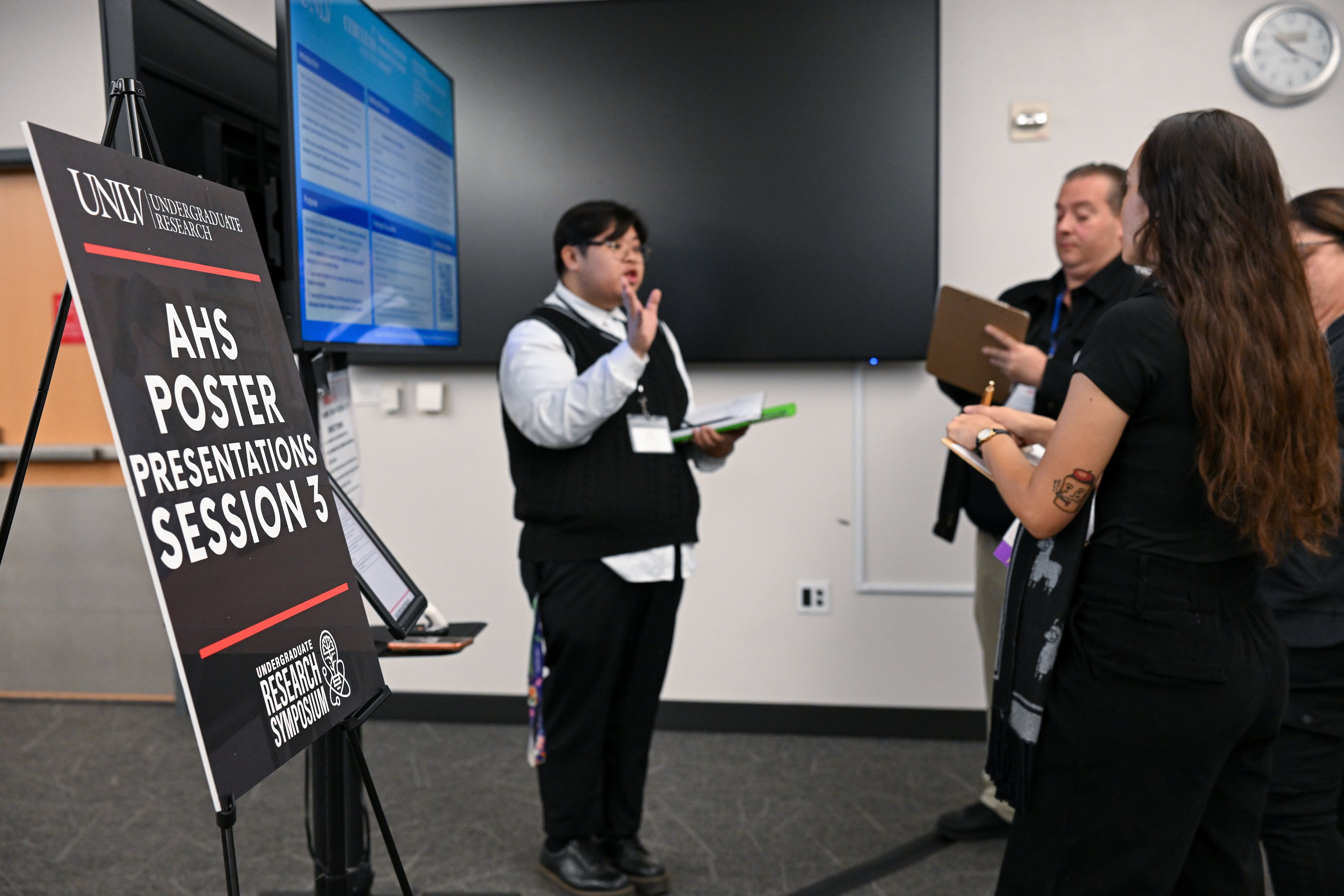 AHS Poster and a presenter speeking