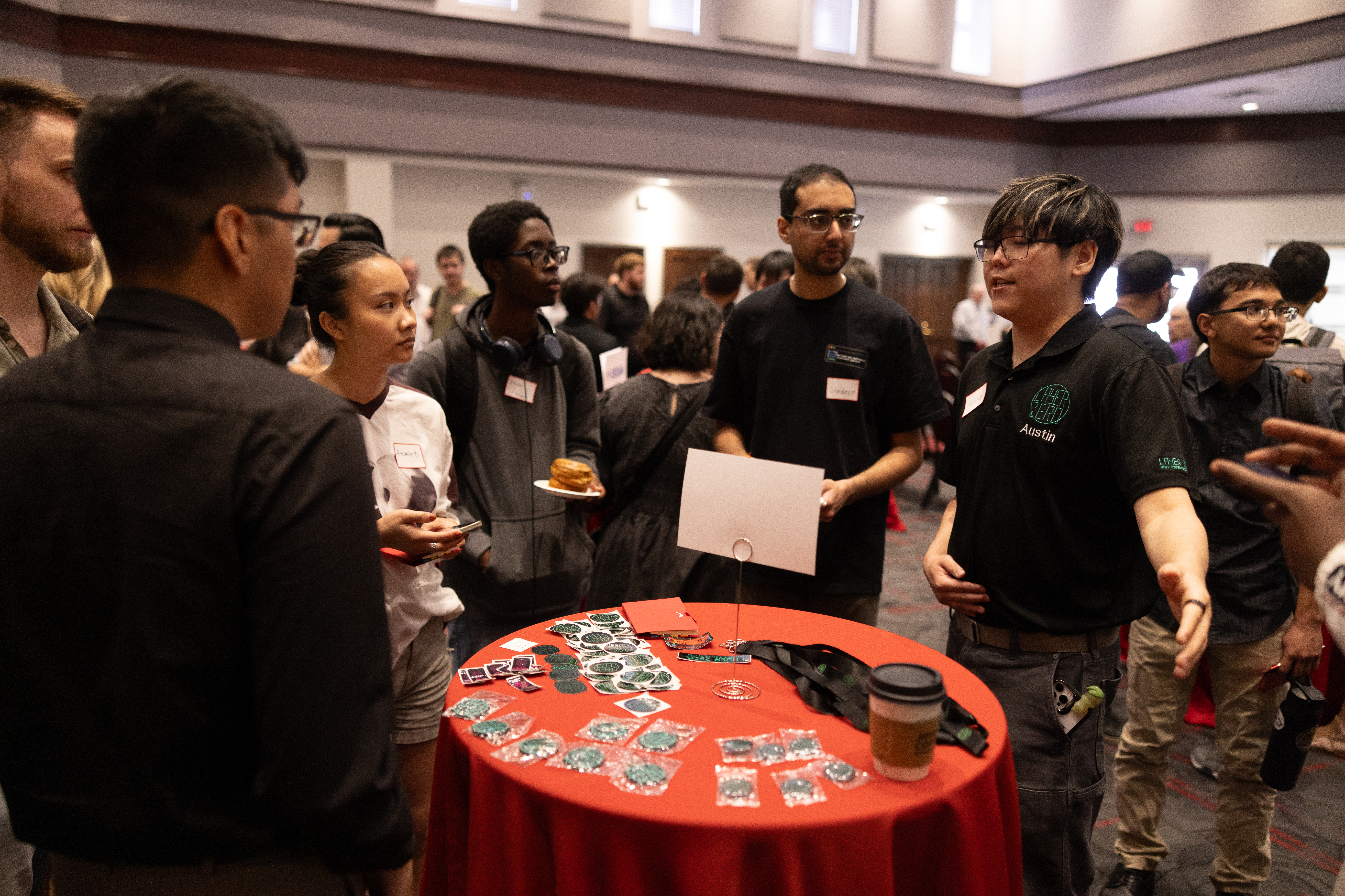 a group of people surrounding a table talking