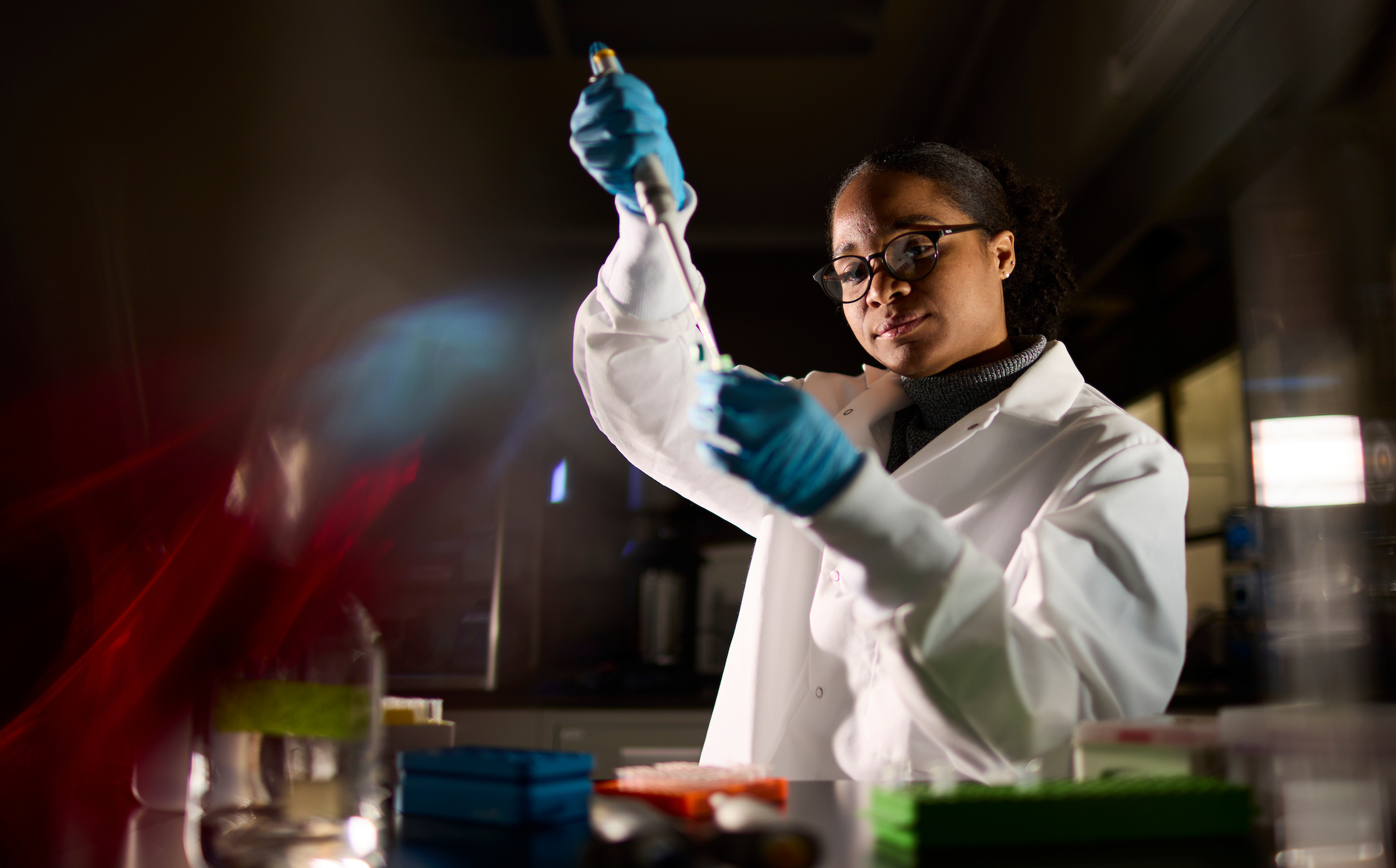 A student in a lab with a test tube