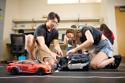 Students work on small automated vehicles
