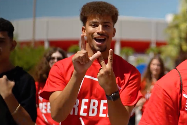 Student makes L.V. symbol with his hands