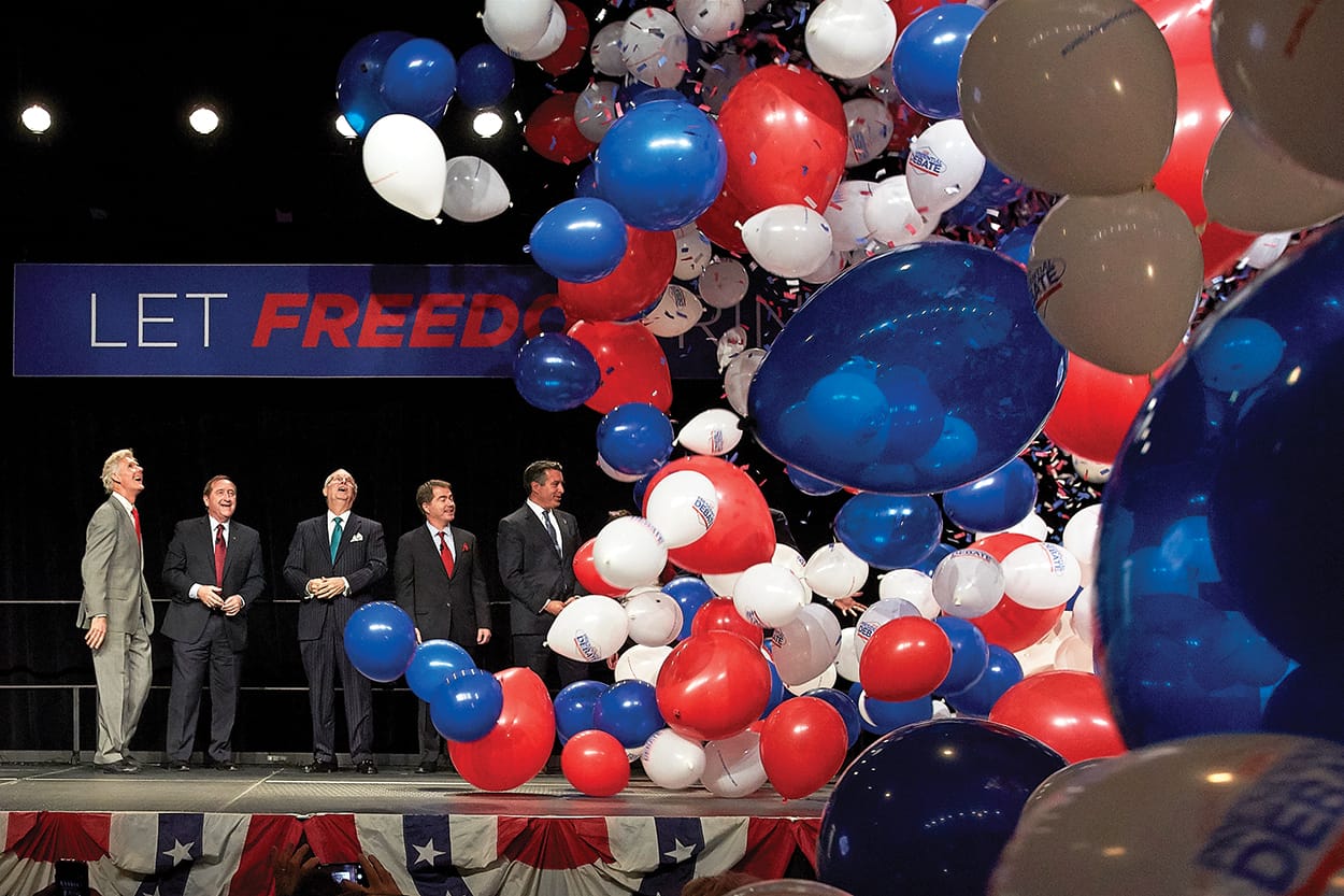 balloons fall from the ceiling at the debate announcement press conference