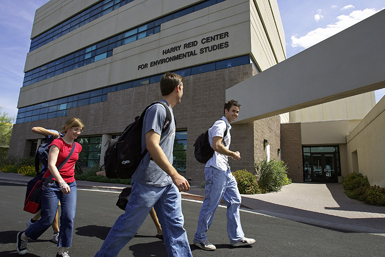 Students walking outside by the Harry Reid Center