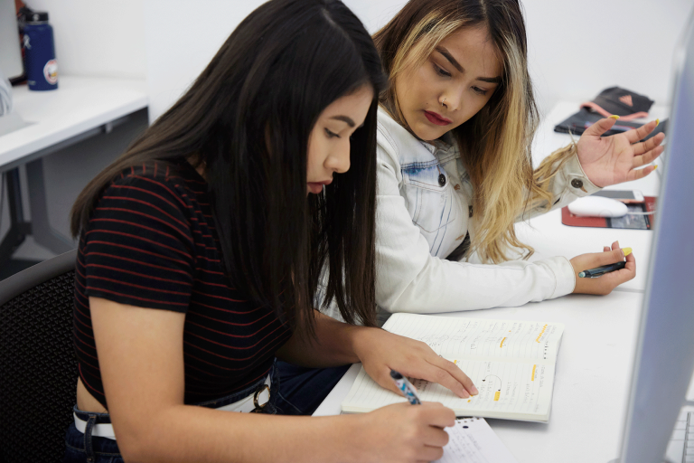 Two students looking at paper