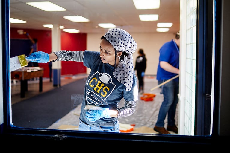 Student works on interior painting