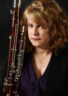 Headshot of Janis McKay with a bassoon