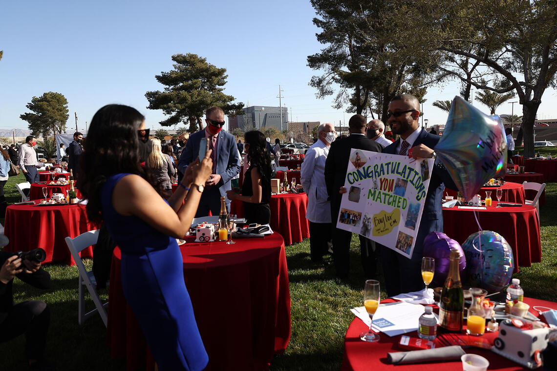 A charter class student holding a congratulatory poster during Match Day