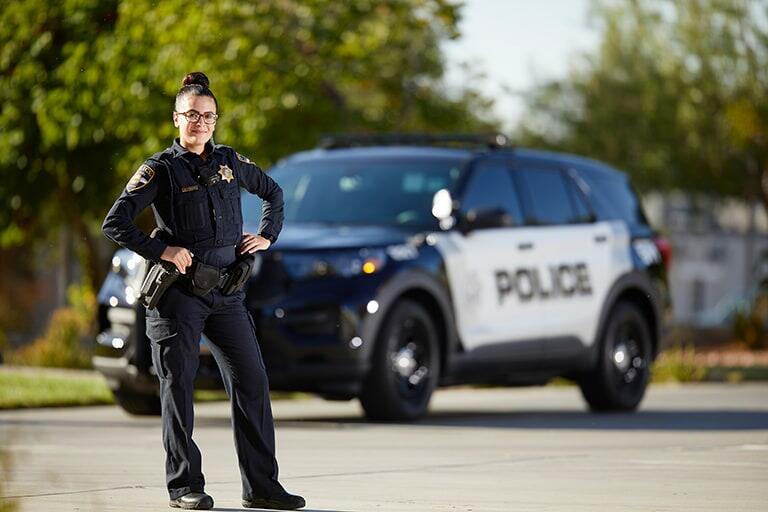 Police officer standing in front of vehicle