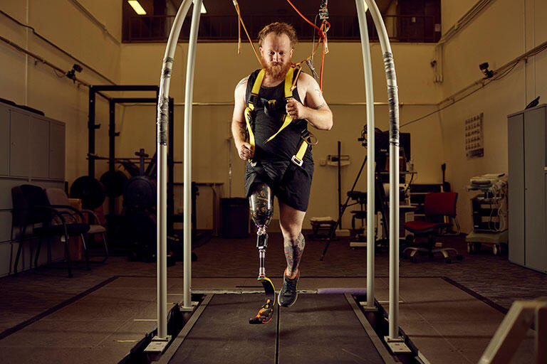 Man running on suspended arched equipment