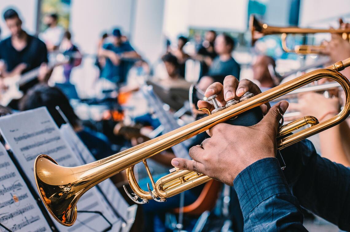 A jazz band rehearsing, focus on cornet