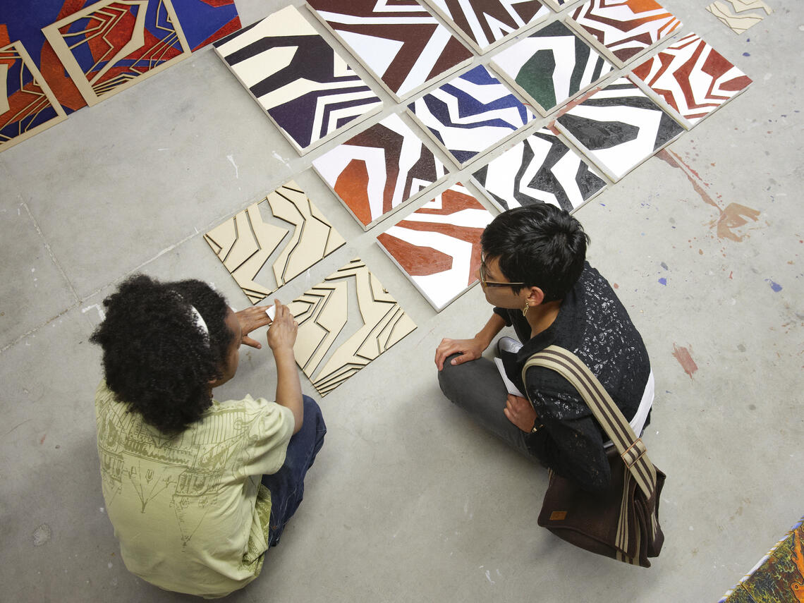 people talking and sitting on the floor