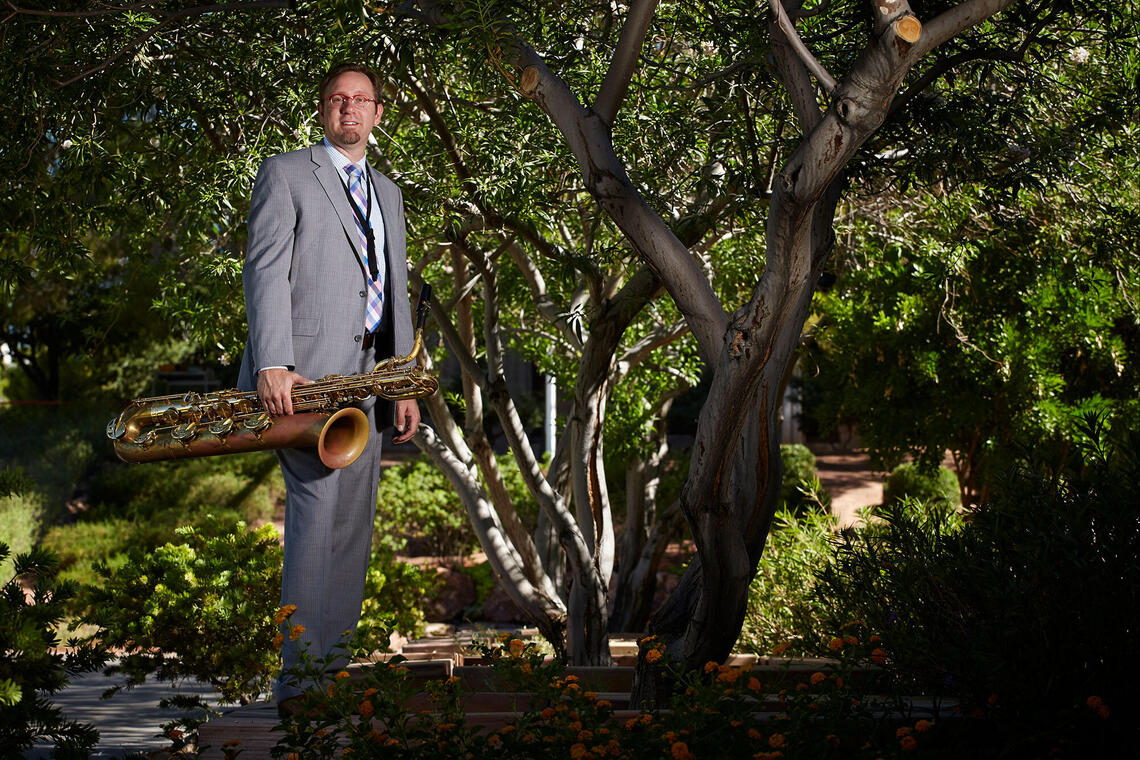 Adam Schroeder (Jazz, Music) standing with his saxophone