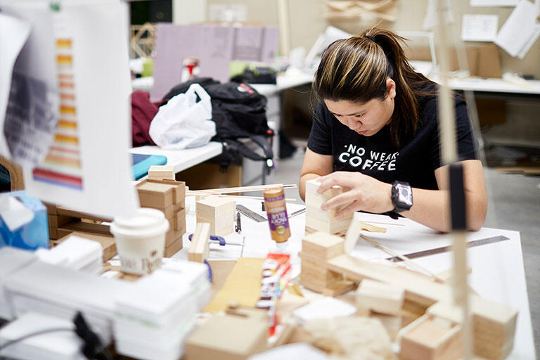 A woman working with wooden blocks