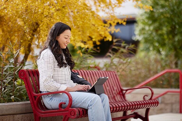 Student works on tablet outside