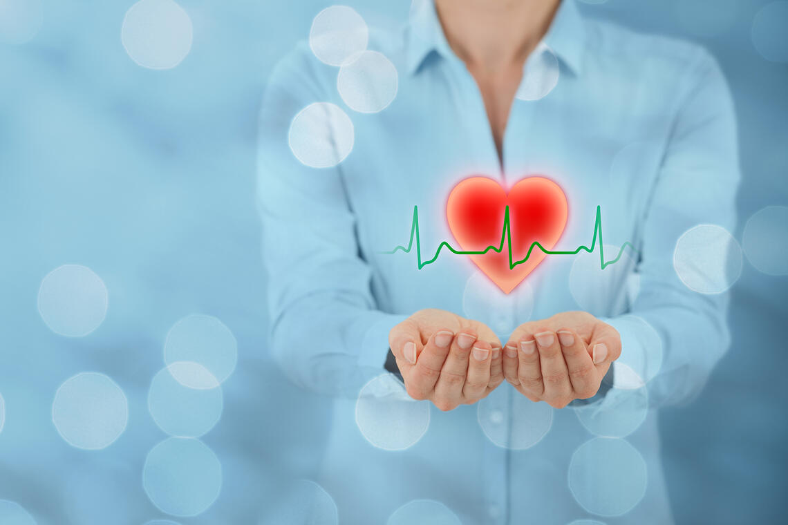 Person holding out hands with a beating heart shape above it